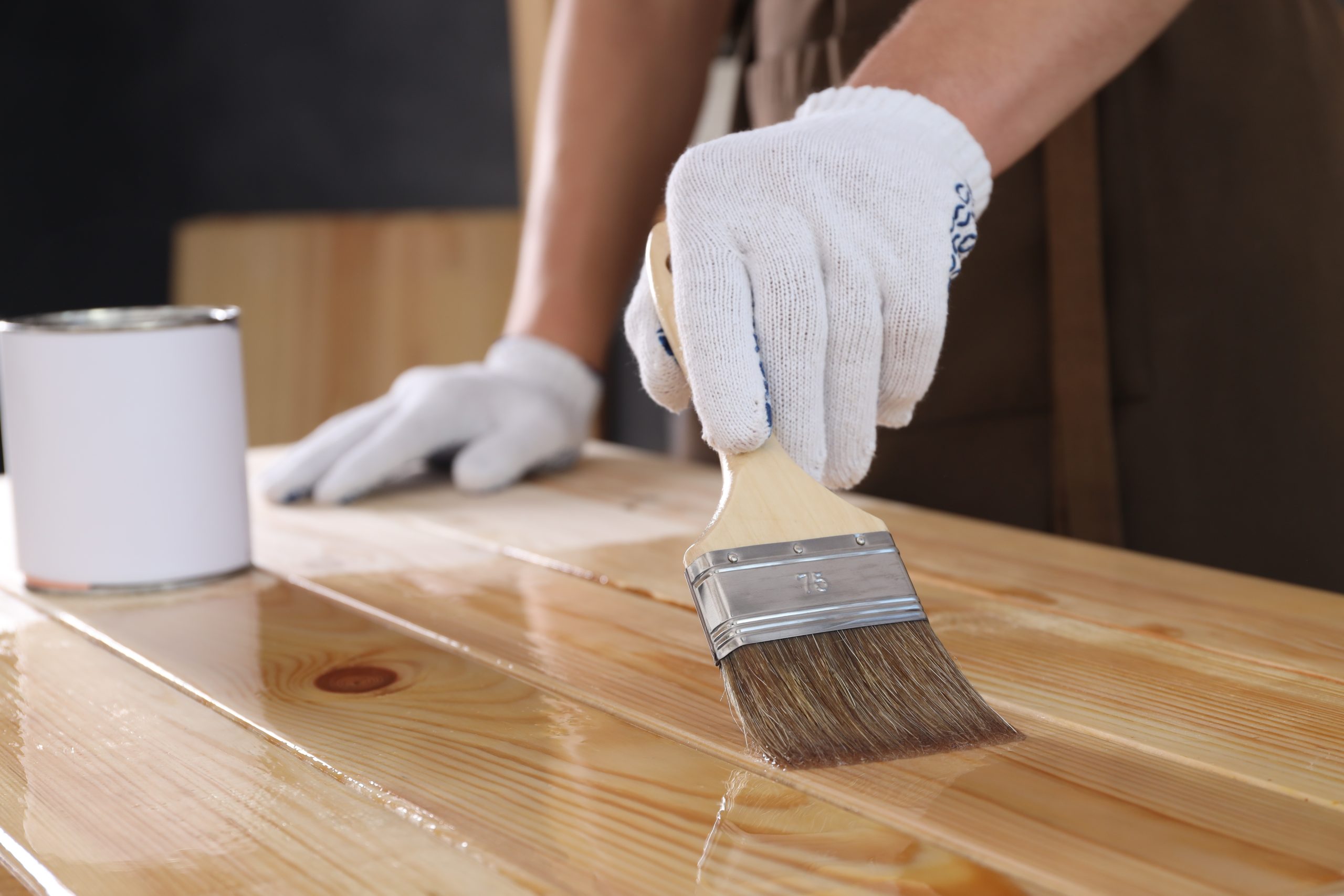 Worktop Refinishing in Tottenham on a solid pine wooden worktop, professional applying clear finish with a brush for a smooth, protected kitchen surface
